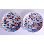 A PAIR OF 18TH CENTURY JAPANESE EDO PERIOD IMARI DISHES painted with a fenced garden and flowers. 2