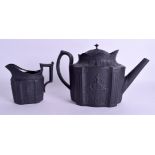 AN EARLY 19TH CENTURY ENGLISH BLACK BASALT TEAPOT AND COVER with matching cream jug. 24 cm & 11 cm