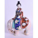 A 19TH CENTURY JAPANESE MEIJI PERIOD AO KUTANI FIGURE OF A GEISHA modelled upon an elephant. 14 cm