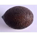 AN EARLY 19TH CENTURY CARVED COCONUT BUGBEAR POWDER FLASK decorated with Indian figures amongst fol