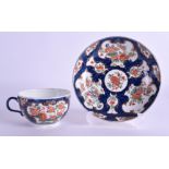 AN 18TH CENTURY WORCESTER TEACUP AND SAUCER painted with kakiemon flowers. (2)