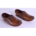 A PAIR OF EARLY 20TH CENTURY CONTINENTAL TREEN CLOGS with flower decoration to foot. 24 cm long.