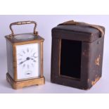 AN EARLY 20TH CENTURY FRENCH CASED BRASS CARRIAGE CLOCK with white enamel dial. 17.5 cm high.