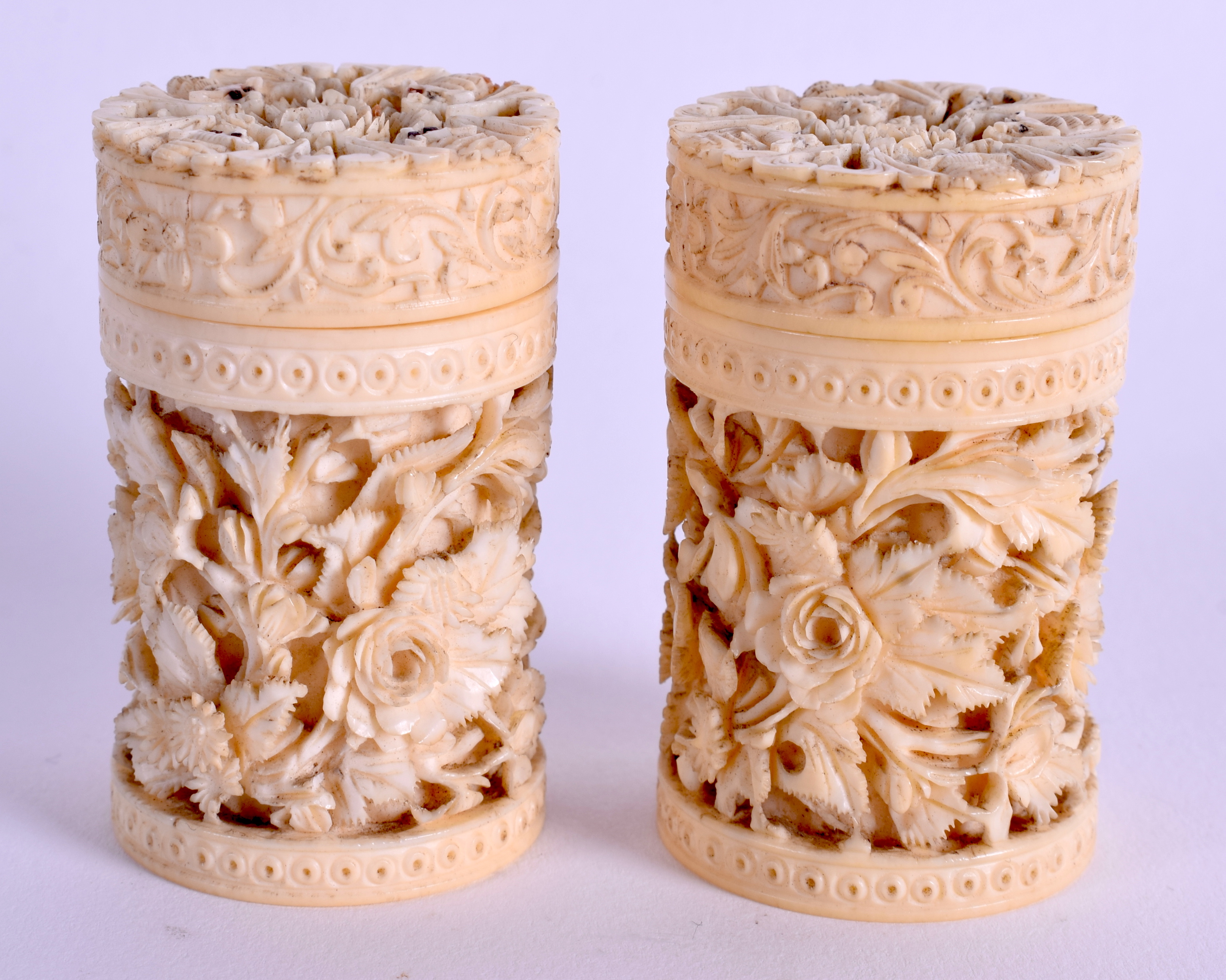 A PAIR OF 19TH CENTURY CHINESE CARVED IVORY CANS. 4.5 cm high.