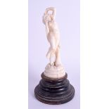 A FRENCH ART NOUVEAU CARVED IVORY FEMALE modelled upon a wood plinth. Ivory 11 cm high.