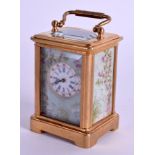 A MINIATURE BRASS AND PORCELAIN CARRIAGE CLOCK. 7 cm high inc handle.