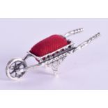 A SILVER WHEELBARROW. 4 cm wide.