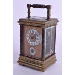 A MINIATURE BRASS CARRIAGE CLOCK. 12 cm high inc handle.