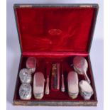 A CASED SILVER BRUSH SET.