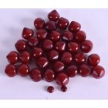 A COLLECTION OF RED AMBER BEADS. 45 grams. (qty)