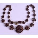 A GEORGIAN GARNET NECKLACE, in the form of graduated stars. 41 cm long.