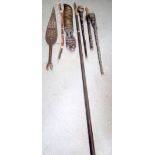 A CARVED TRIBAL THROWING SPEAR, together a paddle and other weapons. Longest 196 cm. (7)