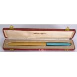 AN EARLY 20TH CENTURY BLUE ENAMEL AND AND IVORY PAPER KNIFE, with fitted case. 21.5 cm long.