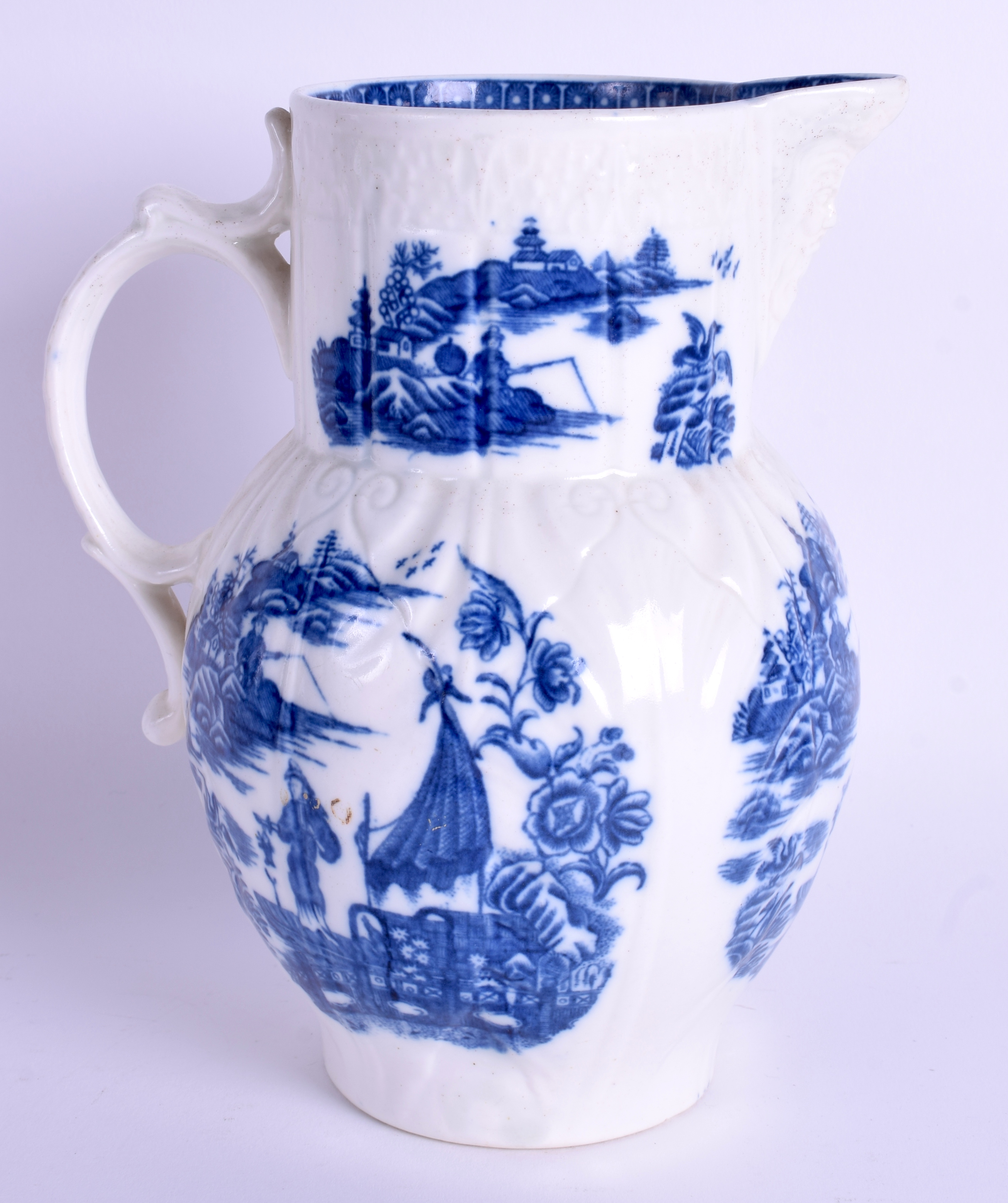 AN 18TH CENTURY CAUGHLEY CABBAGE LEAF MOULDED JUG printed with the fisherman pattern. 19 cm high.