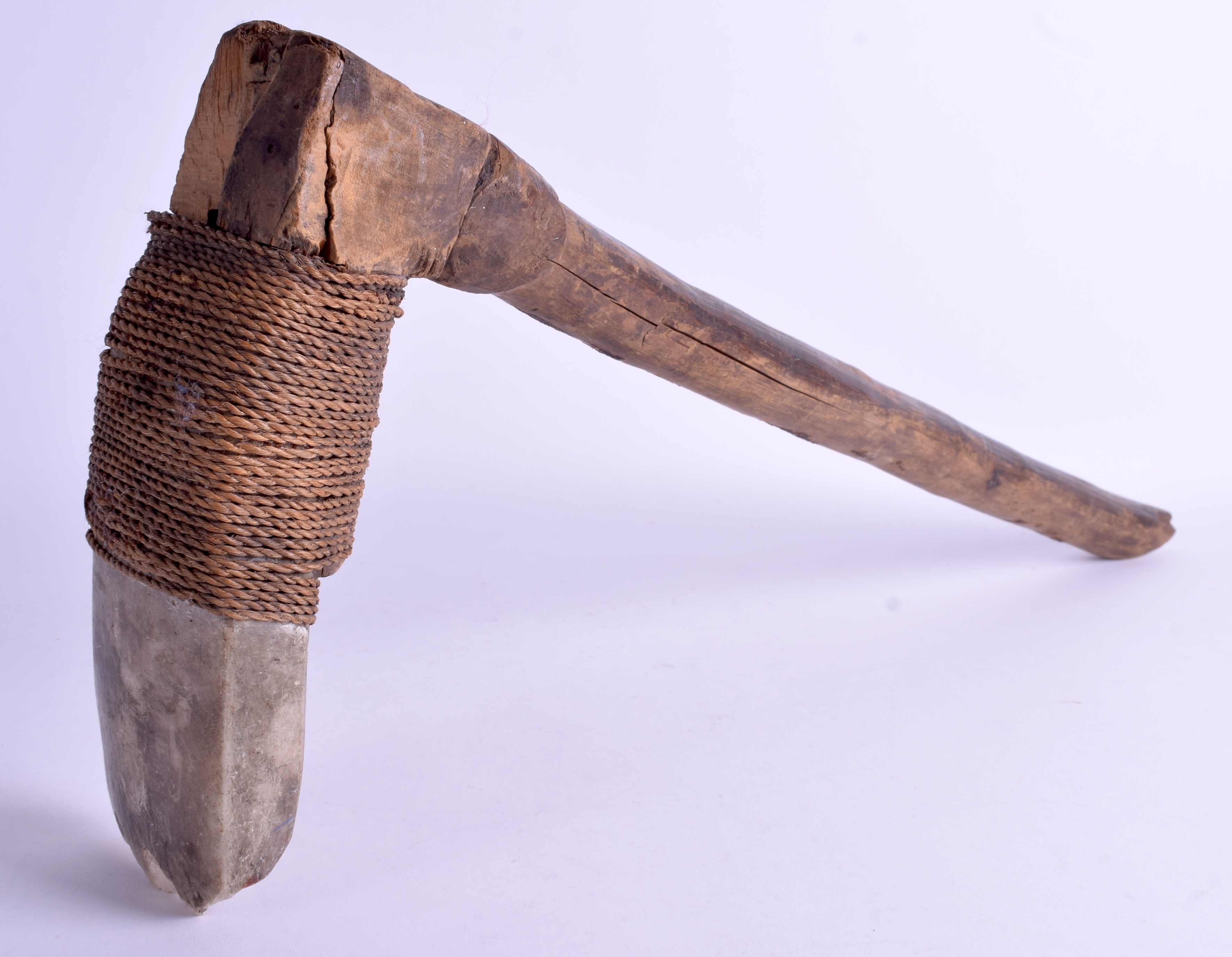 AN UNUSUAL 19TH CENTURY CARVED STONE TRIBAL ROPE BOUND AXE. 56 cm x 25 cm.