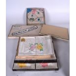 A GROUP OF HAND PAINTED VINTAGE TABLE CLOTH, varying decoration, some with original box. (qty)