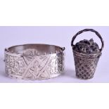 AN ANTIQUE SILVER BANGLE and a silver basket. (2)