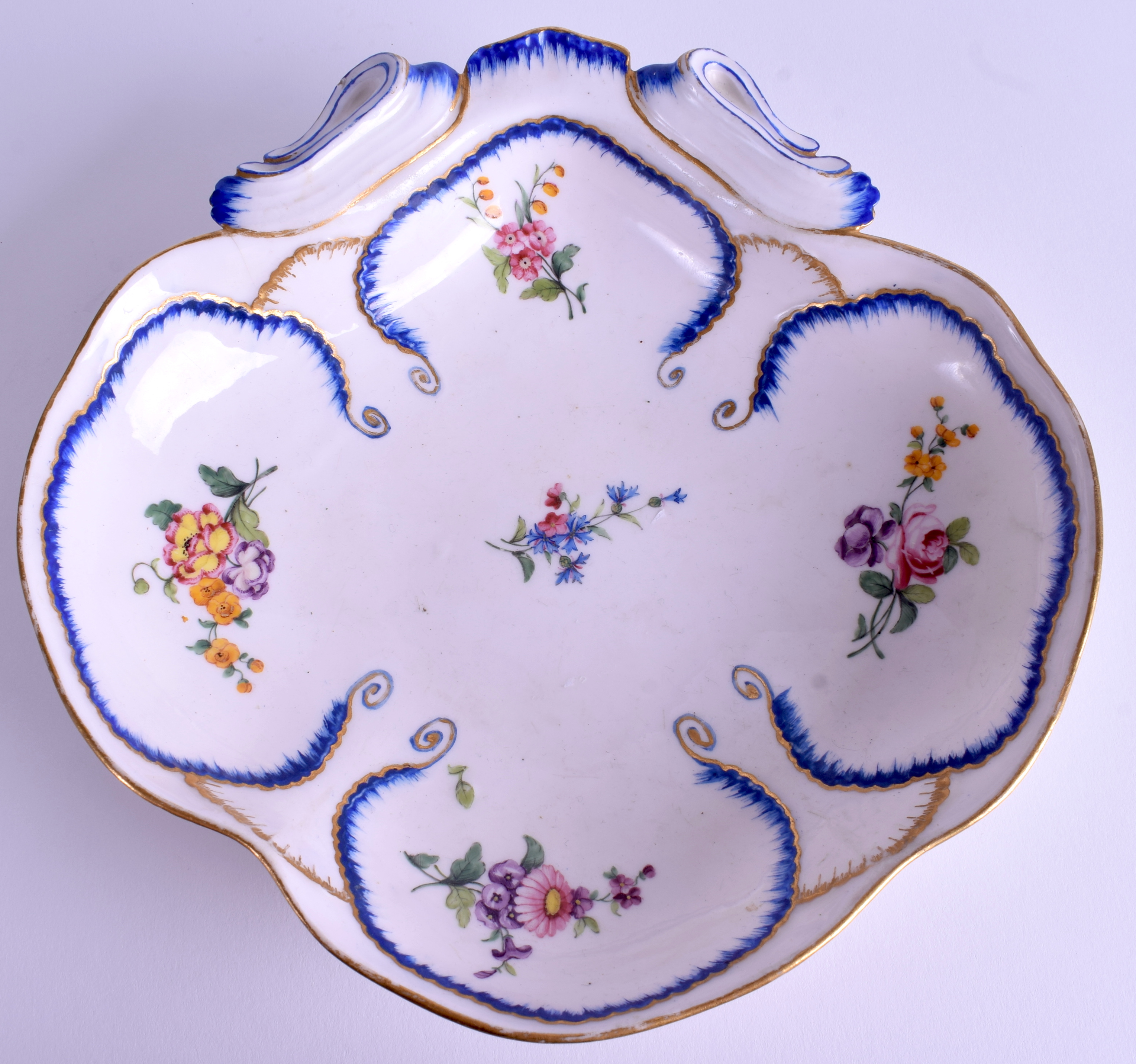 AN 18TH CENTURY SEVRES PORCELAIN SCALLOPED DISH painted with foliage. 22 cm wide.