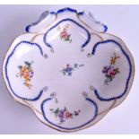 AN 18TH CENTURY SEVRES PORCELAIN SCALLOPED DISH painted with foliage. 22 cm wide.