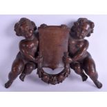 A 19TH CENTURY CONTINENTAL FRUIT WOOD DOUBLE CHERUB PLAQUE. 32 cm x 20 cm.