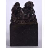 A CHINESE CARVED STONE SEAL, the terminal in the form of three rams upon a rocky outcrop. 8 cm high