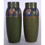 A PAIR OF EARLY 20TH CENTURY ROYAL DOULTON POTTERY VASE, painted with floral banding. 24 cm high.