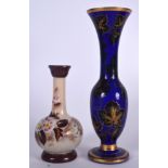 AN EARLY 20TH CENTURY FRENCH OVERLAID GLASS VASE, together with a larger blue glass vase gilded wit