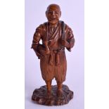 A 19TH CENTURY JAPANESE MEIJI PERIOD CARVED BOXWOOD OKIMONO modelled as a male holding a bird. 14 c