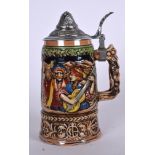 A GERMAN PORCELAIN MUSICAL TANKARD OR STEIN, decorated with musicians in a landscape. 21 cm high.