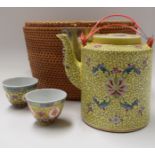 A 20TH CENTURY CHINESE FAMILLE JAUNE PORCELAIN TEA POT, contained within a fitted basket. Basket 20