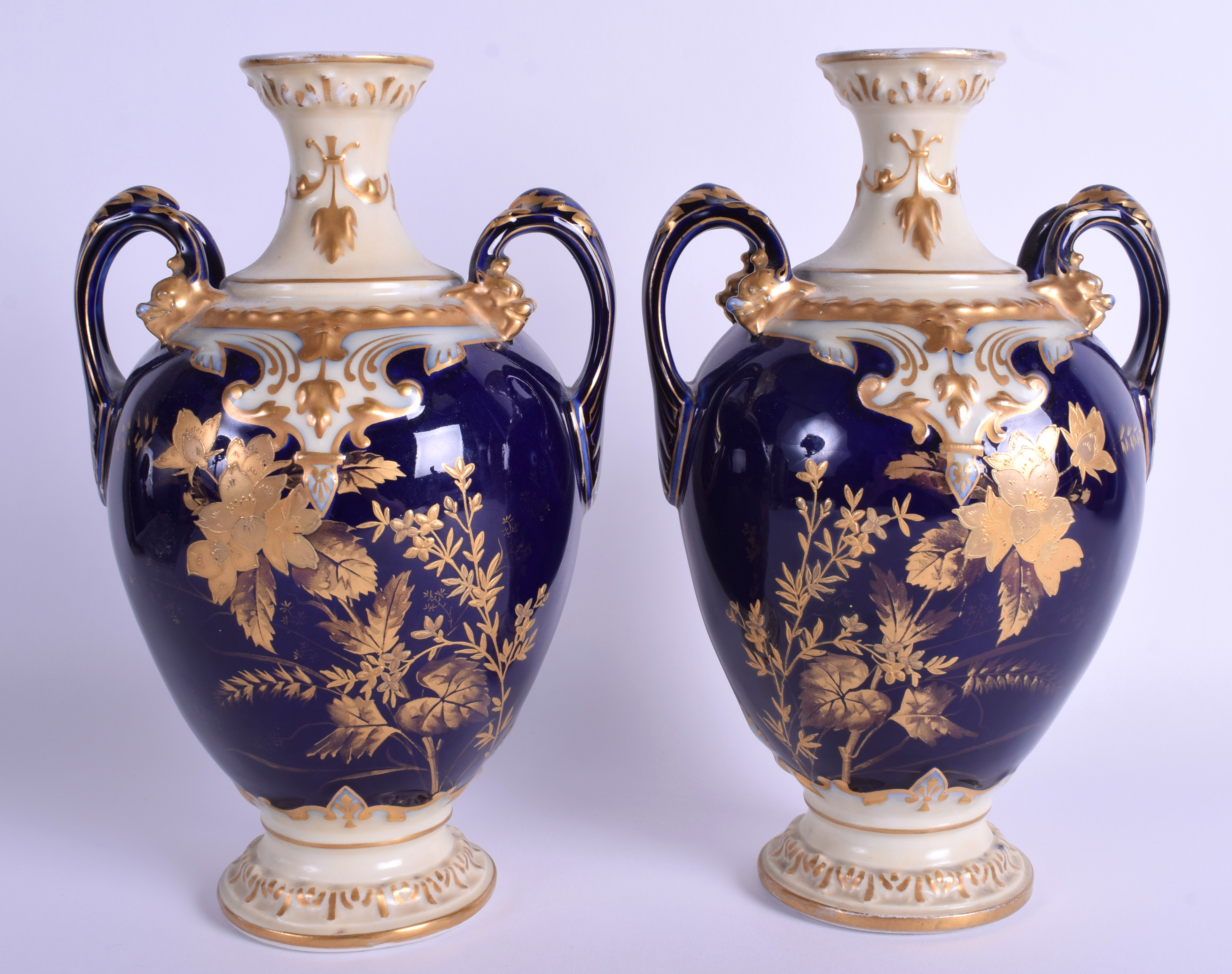 A PAIR OF FRENCH LIMOGES PORCELAIN VASES decorated with foliage. 24 cm high.