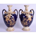 A PAIR OF FRENCH LIMOGES PORCELAIN VASES decorated with foliage. 24 cm high.