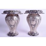 A PAIR OF ANTIQUE NEO CLASSICAL SILVER EMBOSSED VASES. 32.5 oz. 19 cm x 13 cm.