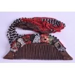 AN UNUSUAL EARLY 20TH CENTURY TRIBAL CARVED WOOD COMB with bead work mounts. Comb 13 cm x 5 cm.