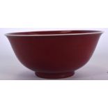 A CHINESE SANG DE BOUEF PORCELAIN BOWL BEARING XUANDE MARKS, formed with a white rim. 21.5 cm wide.