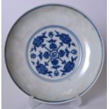 A CHINESE BLUE AND WHITE PORCELAIN DISH BEARING YONGZHENG MARKS. painted with stylised foliage. 17