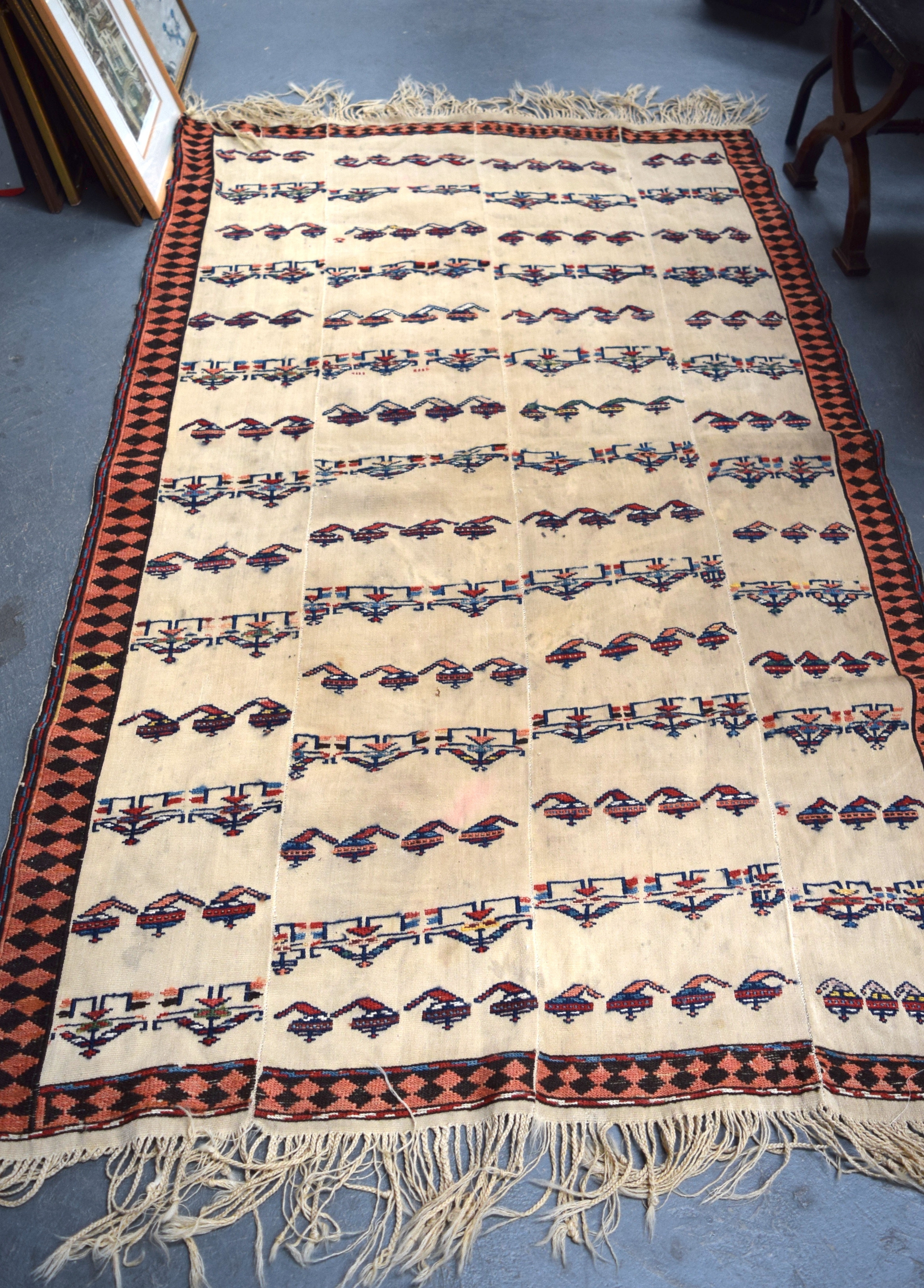 A RARE ANTIQUE 19TH/20TH CENTURY NAVAJO NATIVE AMERICAN RUG, decorated with figures and stylised ob