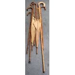 FIVE ANTIQUE WALKING STICKS, together with two parasols. (7)