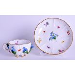 A MEISSEN ENCRUSTED PORCELAIN CUP AND SAUCER encrusted with flowers. (2)