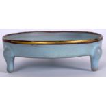 A CHINESE SUNG STYLE PALE BLUE GLAZED PORCELAIN TRIPOD CENSER, formed on three curving feet and fit