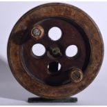 AN ANTIQUE CARTER AND CO. TYPE WOODEN SEA FISHING REEL, stamped “Made in England”. 15.5 cm wide.