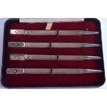 A CASED SET OF FOUR SOLID SILVER PROPELLING PENCILS OF GAMBLING INTEREST, decorated with playing ca
