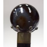 A NIGHT WATCHMAN TYPE AGATE TOP WALKING CANE, formed with white metal mounts. 101 cm long.