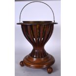 AN EARLY 20TH CENTURY WOODEN BUCKET, formed with brass liner and reeded body. 59 cm to handle.