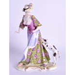 A 19TH CENTURY GERMAN PORCELAIN FIGURE OF A FEMALE modelled in a coloured dress beside a hound. 19
