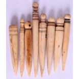 A COLLECTION OF ANTIQUE ESKIMO NORTH AMERICAN INUIT WHALE BONE FIDS. Largest 8.5 cm long. (8)