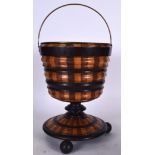 AN EARLY 20TH CENTURY WOODEN BUCKET, formed with brass liner and ribbed body. 56 cm to handle.