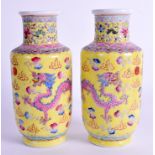 A PAIR OF EARLY 20TH CENTURY CHINESE FAMILLE JAUNE VASES painted with dragons. 17 cm high.