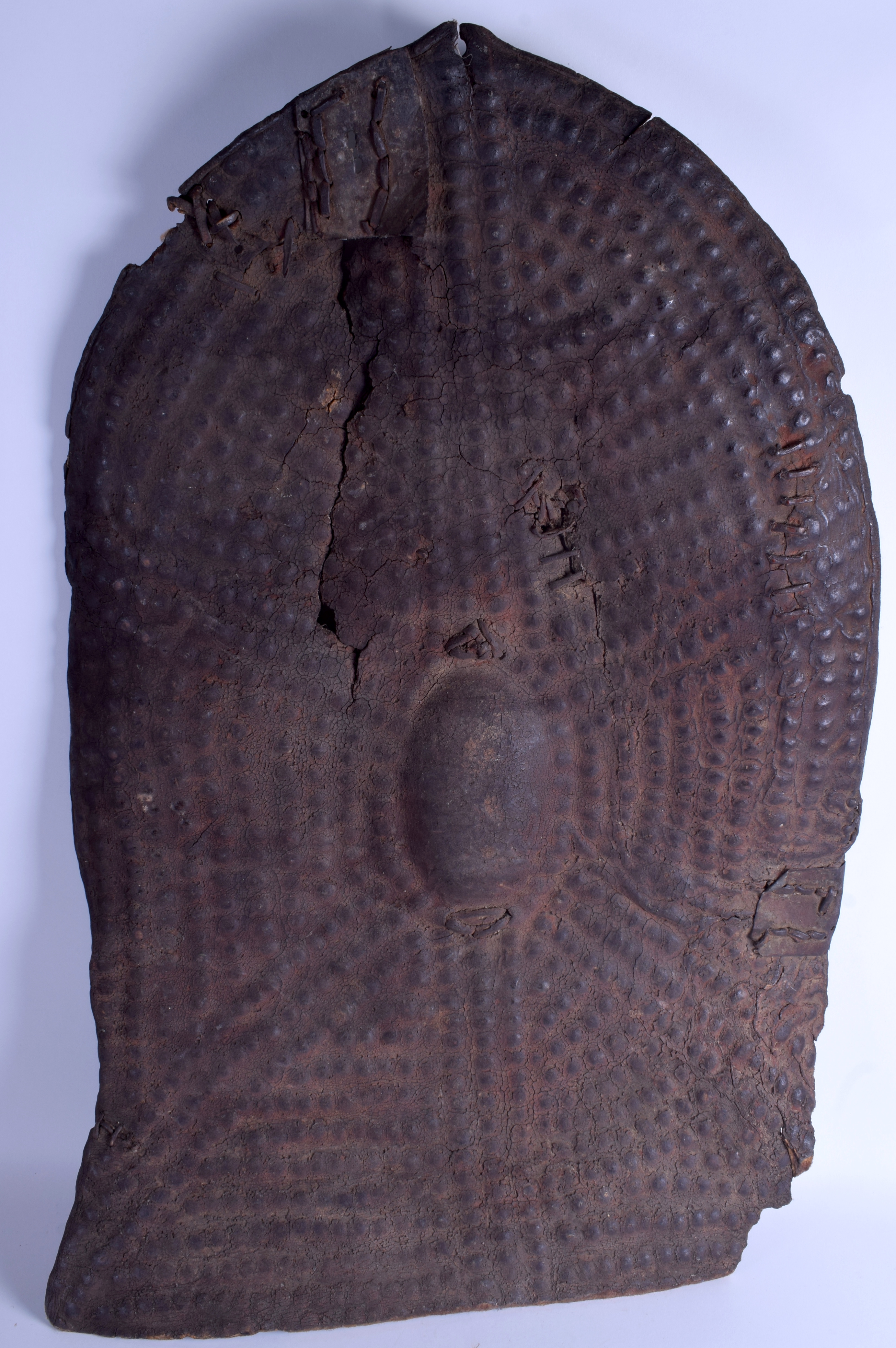 A 19TH CENTURY AFRICAN RHINOCEROS HORN HIDE SHIELD with dimpled decoration, possibly Ethiopian. 94