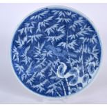 A LATE 19TH CENTURY CHINESE BLUE AND WHITE PORCELAIN DISH, decorated with a bird beside flowering r